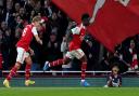 Arsenal\'s Bukayo Saka (right) celebrates scoring their third goal against Liverpool