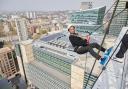 Mayor of Camden Cllr Nasim Ali abseils down an 18-floor building in Euston for Hopscotch