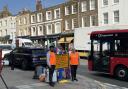 Volunteers Helen Rapley and Taha Gulamhusein directing traffic in Highgate High Street