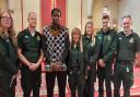 Joshua with paramedics who saved his life after he suffered a cardiac arrest on the top deck of a bus (Image: LAS)