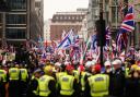 Supporters of a Pro-UK rally endorsed by Tommy Robinson march from Victoria Station to Parliament Square in central London.