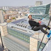 Mayor of Camden Cllr Nasim Ali abseils down an 18-floor building in Euston for Hopscotch