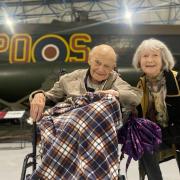 Stuart Black with wife Crystal next to a Lancaster bomber at RAF Museum London