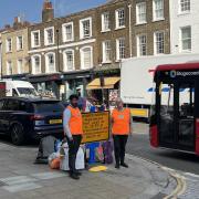 Volunteers Helen Rapley and Taha Gulamhusein directing traffic in Highgate High Street