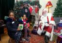 At Lauderdale House - Eve (7), Helena (5) and mum Andrea Bara-Bara meet Father Christmas