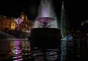 A Chanukiah and a Christmas tree share space in Trafalgar Square