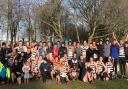 Highgate Harriers men celebrate their Met League title double in 2020, with captain Rob Wilson (front row, centre) leading the cheers