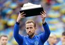 Harry Kane holds up a golden boot for becoming England's all-time record goalscorer ahead of their match against Ukraine at Wembley Stadium