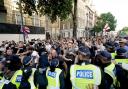 Police officers clash with protesters in Whitehall following the fatal stabbing of three children at a Taylor Swift-themed holiday club in Southport.