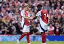 Arsenal's Martin Odegaard (left) gives the captain's armband to Bukayo Saka Image: PA