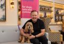 Comedian Ricky Gervais poses with Murphy the therapy dog at a World Animal Day event in aid of charity Mayhew.