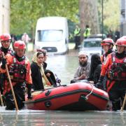 A family being rescued from the floods in Clapton on Wednesday morning. Picture: Paul Wood