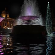 A Chanukiah and a Christmas tree share space in Trafalgar Square