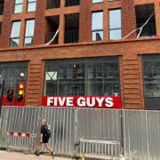 A sign on the front of the upcoming Five Guys burger restaurant in West Hampstead