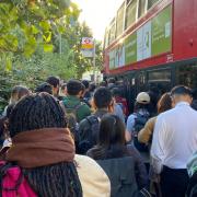 Bus passengers in September trying to board in a large crowd