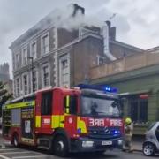 Smoke pours from a ventilation flue during a fire at the Parakeet pub in Kentish Town