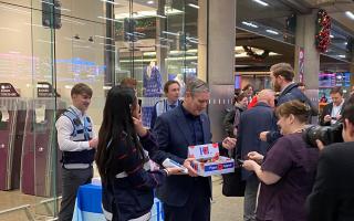 Sir Keir Starmer giving out poppies at Kings Cross Station