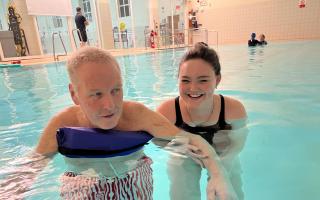 'Unsung Hero' Megan Allen helping swimmer John at the Park Road Pool in Crouch End