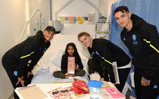 Players handed out Christmas gifts on a children's ward at the Royal Free