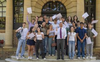 UCS headmaster Mr Beard celebrates A-level results with students