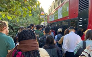 Bus passengers in September trying to board in a large crowd