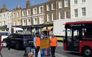 Volunteers Helen Rapley and Taha Gulamhusein directing traffic in Highgate High Street