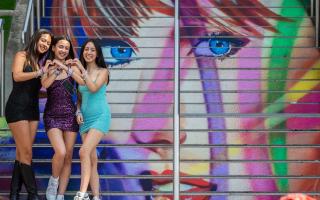 Swifties pose on Wembley Park's Taylor Swift steps during one of the Era's tour concerts this summer